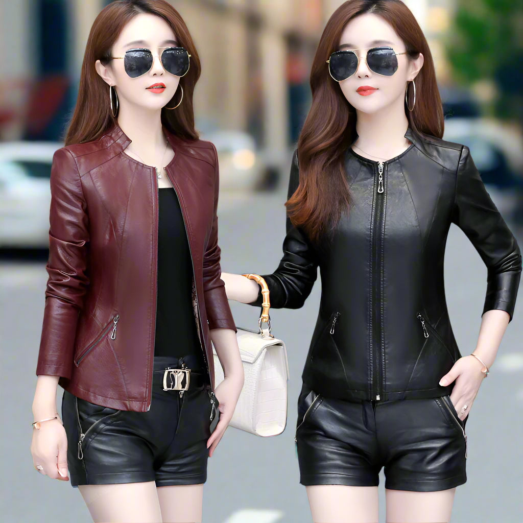 Two women wearing leather jackets and shorts on a blurred street background